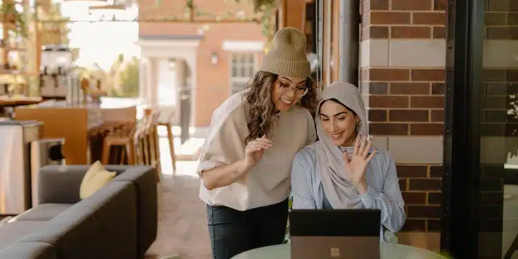 a woman sitting at a table using a laptop