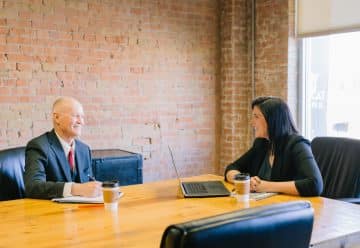 man and woman talking inside office